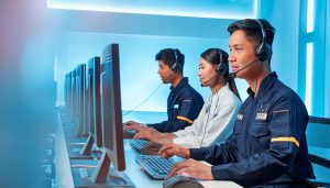 People in a call center sitting at computers while wearing headsets